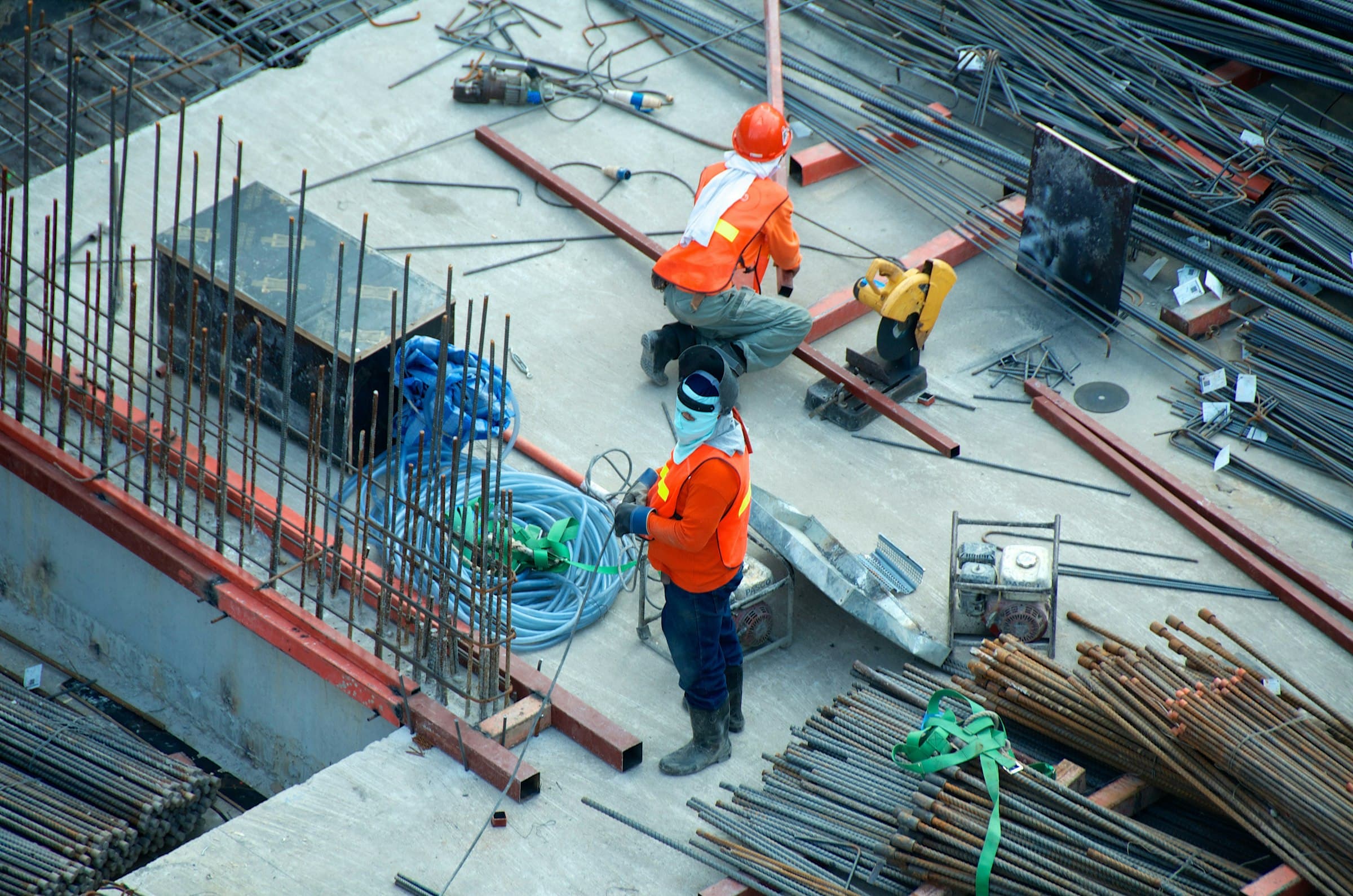Workers tying steel reinforcement on a construction deck