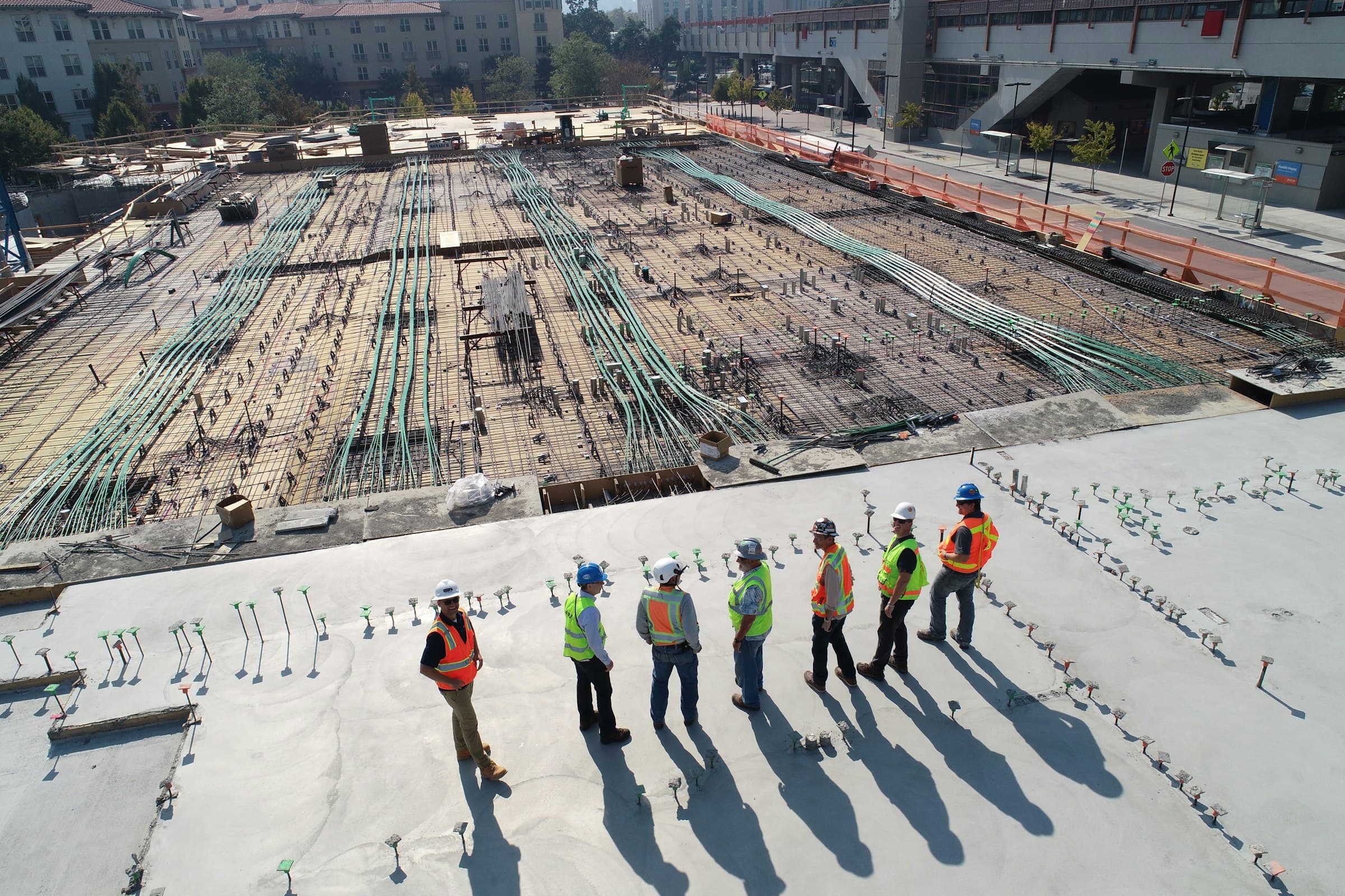 Site engineers standing on a large concrete slab under construction