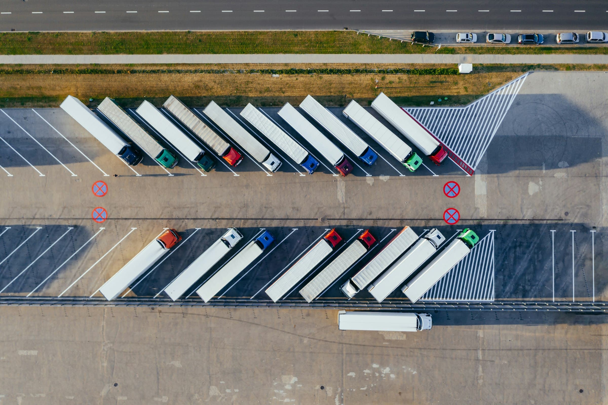 Aerial view of trailers parked in bays beside a distribution centre