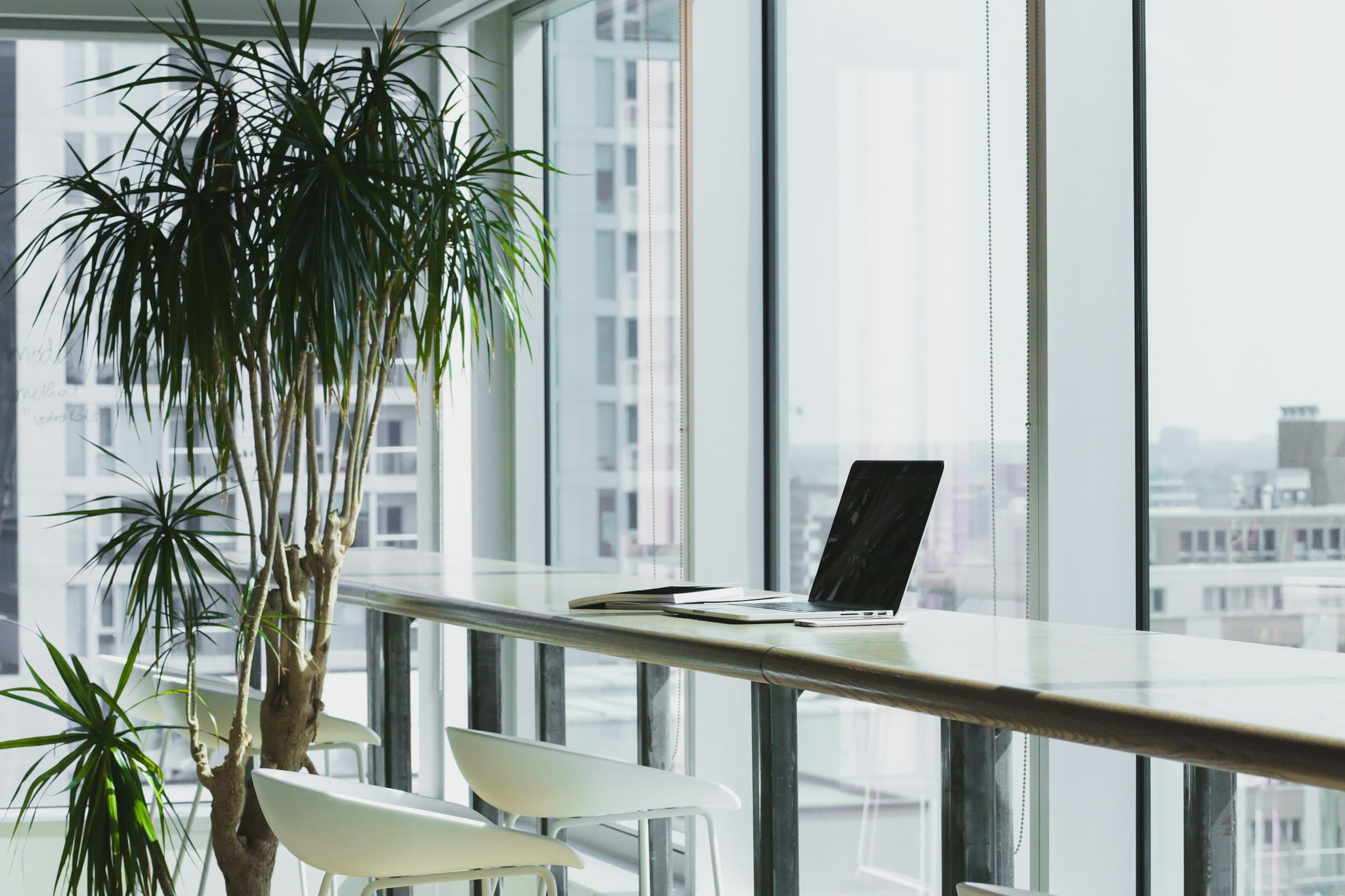 A quiet workspace beside tall windows overlooking the city